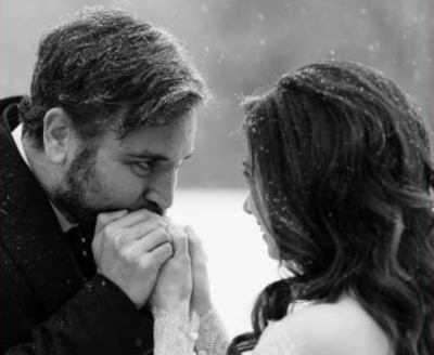 Josh Radnor kissing the hands of his wife, Jordana Jacobs.